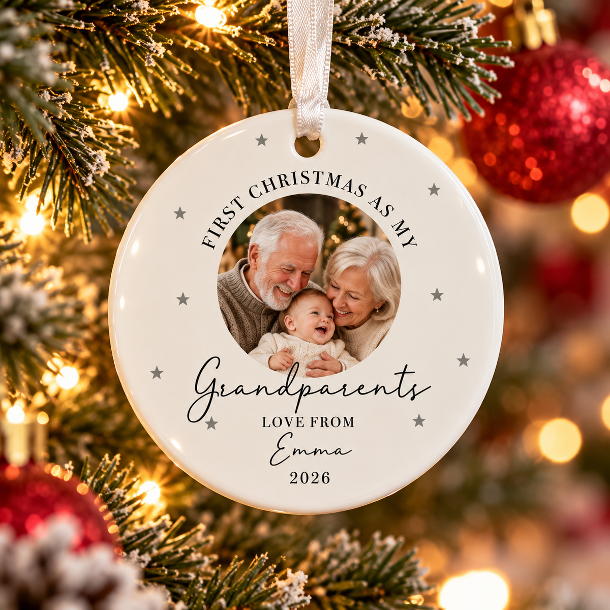 Grandparents photo ornament with granddaughter Emma hanging on illuminated Christmas tree